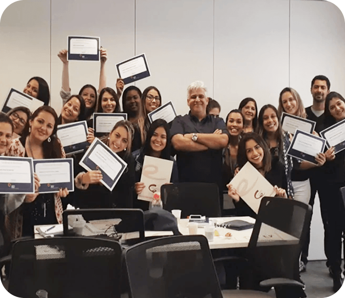Walter Coelho palestrante de vendas em treinamento corporativo com equipe reunida mostrando certificados de conclusão.